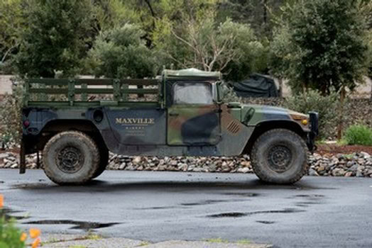 Maxville Winery truck parked on a paved road with trees in the background.