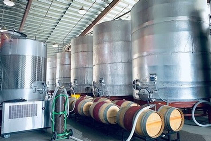 Large stainless steel wine fermentation tanks at Maxville Winery for wine production.
