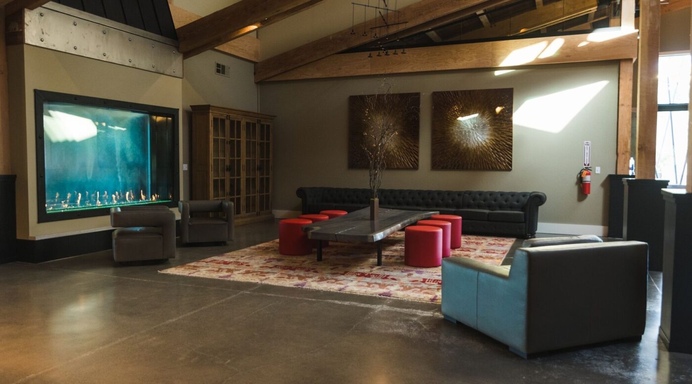 Modern winery lounge with aquarium, colorful seating, and artwork, perfect for relaxing at Maxville Winery.